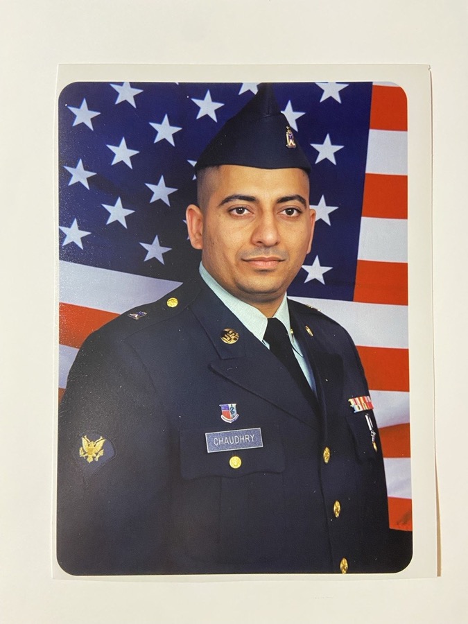 Zahid Chaudhry in U.S. Army dress uniform, American flag backdrop.